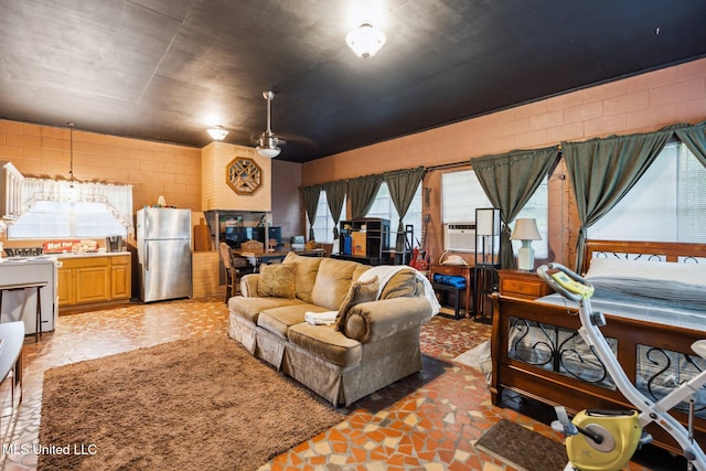 living room featuring a healthy amount of sunlight and ceiling fan