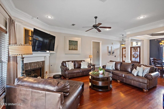 living room featuring dark wood-type flooring, crown molding, and a premium fireplace