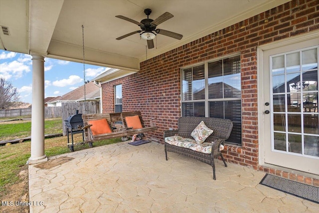 view of patio with ceiling fan and fence