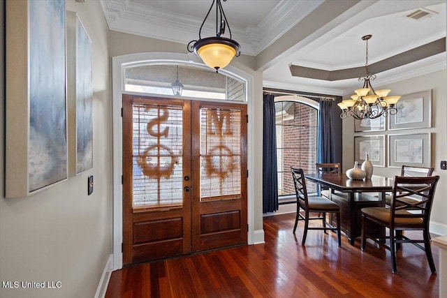 foyer with a chandelier, visible vents, french doors, dark wood finished floors, and crown molding