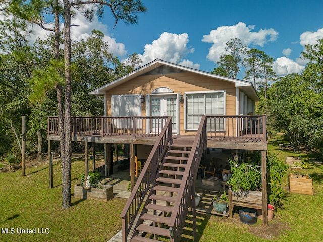 back of property with a lawn and a wooden deck