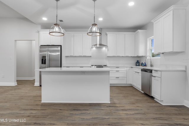 kitchen featuring pendant lighting, appliances with stainless steel finishes, a kitchen island, and white cabinets