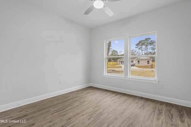 spare room featuring wood-type flooring and ceiling fan