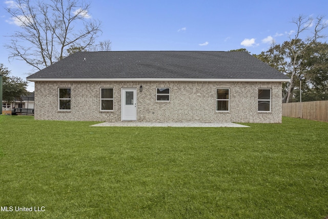 back of house with a patio and a yard