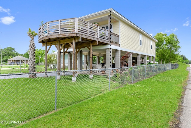 view of front facade with stairs, fence, a deck, a patio area, and a front yard