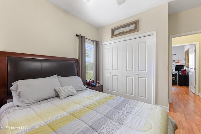 bedroom with a ceiling fan, a closet, baseboards, and wood finished floors