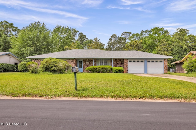 single story home featuring a front lawn, brick siding, driveway, and a garage