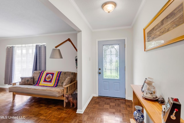 foyer entrance with ornamental molding and baseboards