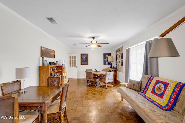 dining area featuring ceiling fan, crown molding, baseboards, and visible vents