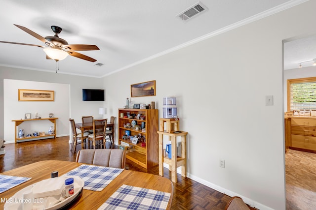 dining space with a ceiling fan, baseboards, crown molding, and visible vents