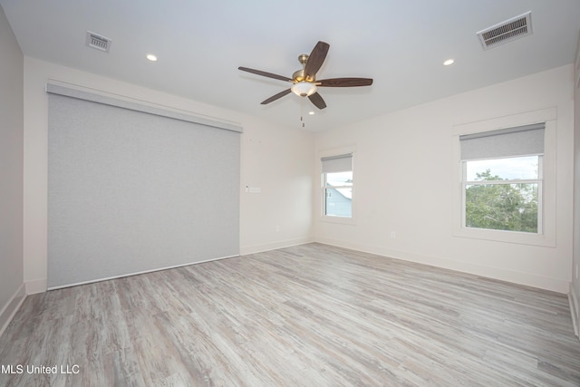 unfurnished room featuring light hardwood / wood-style flooring, plenty of natural light, and ceiling fan