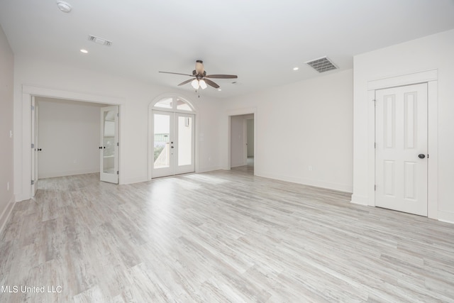 unfurnished room featuring ceiling fan, french doors, and light wood-type flooring