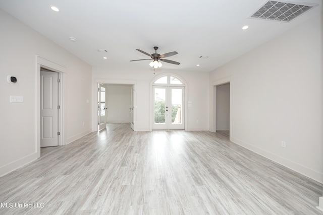 unfurnished living room featuring ceiling fan, french doors, and light hardwood / wood-style floors