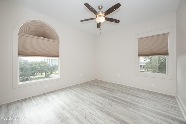 spare room with ceiling fan, baseboards, and wood finished floors