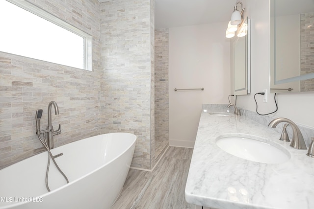 bathroom with a bathing tub, vanity, and hardwood / wood-style flooring