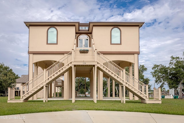 view of front of home featuring stairway, a front lawn, and french doors