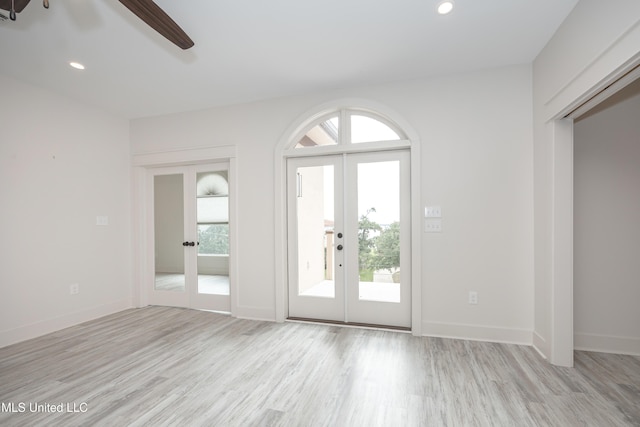 foyer entrance featuring french doors, light wood-type flooring, and ceiling fan