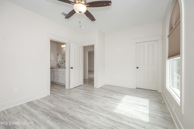 unfurnished bedroom featuring baseboards, visible vents, and light wood finished floors