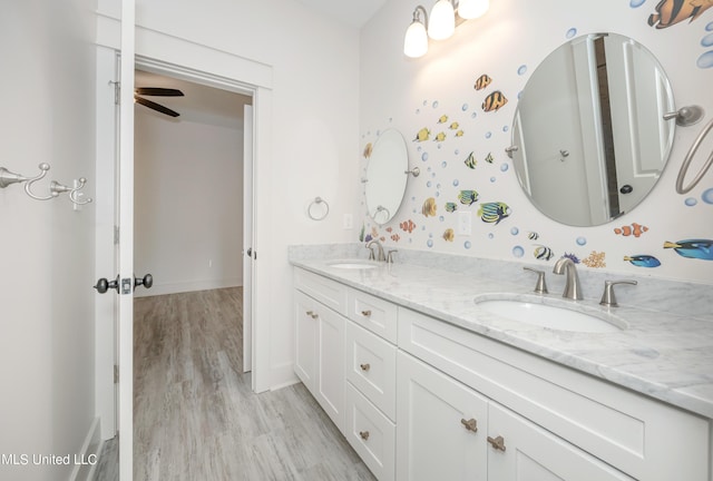 bathroom featuring hardwood / wood-style floors, vanity, and ceiling fan