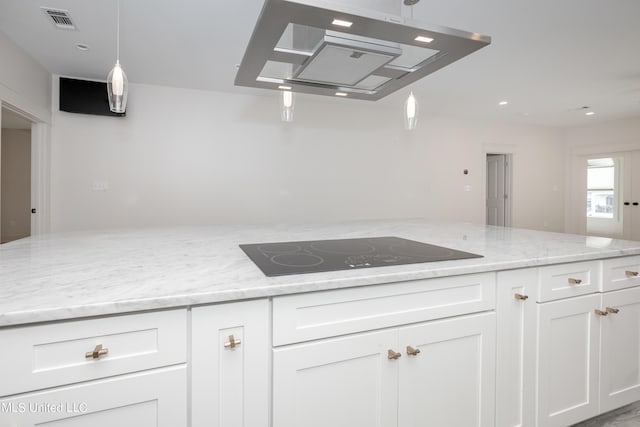 kitchen featuring visible vents, white cabinets, light stone countertops, under cabinet range hood, and black electric cooktop