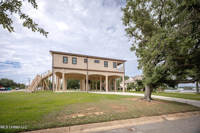 exterior space with stairs and a lawn