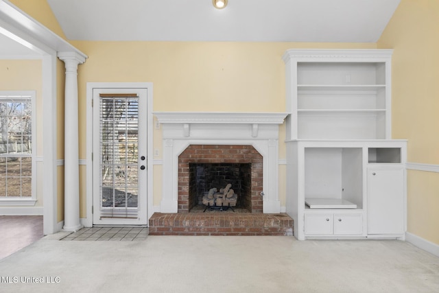 unfurnished living room with vaulted ceiling, light carpet, and a wealth of natural light