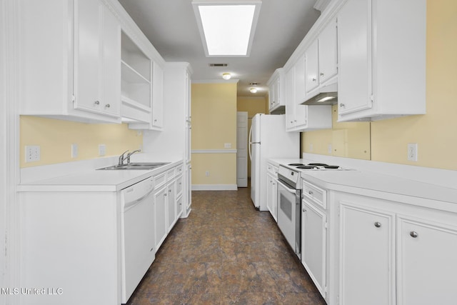 kitchen with white appliances, sink, and white cabinets