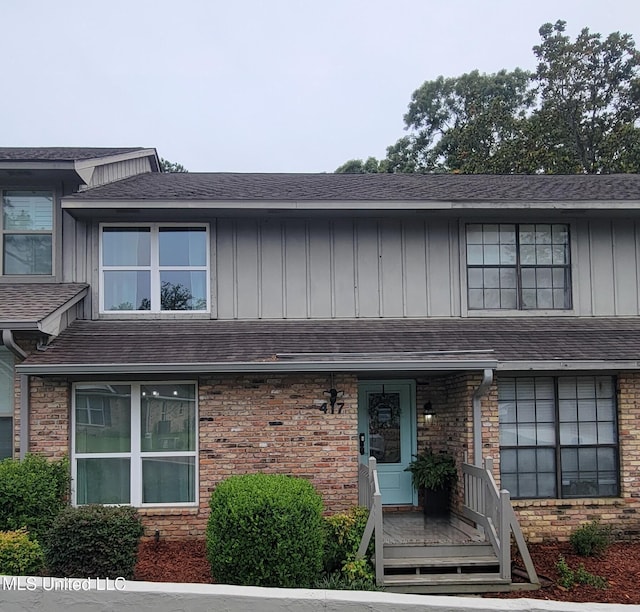 417 Highpoint Dr, Diamondhead, MS 39525 - multi unit property with board and batten siding, roof with shingles, and brick siding