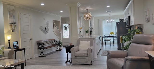 417 Highpoint Dr, Diamondhead, MS 39525 - living area with a chandelier, stairway, light wood-type flooring, baseboards, and recessed lighting