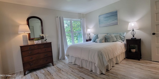 417 Highpoint Dr, Diamondhead, MS 39525 - bedroom featuring light wood-style flooring and baseboards