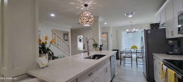 417 Highpoint Dr, Diamondhead, MS 39525 - kitchen featuring a chandelier, a sink, appliances with stainless steel finishes, light countertops, and crown molding