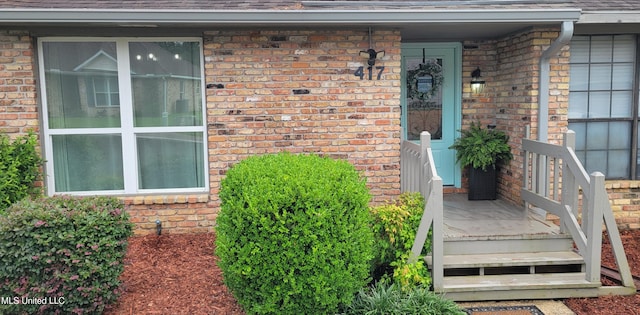 417 Highpoint Dr, Diamondhead, MS 39525 - property entrance with brick siding and a shingled roof