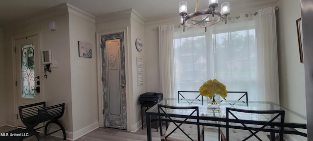 417 Highpoint Dr, Diamondhead, MS 39525 - dining room with a chandelier, baseboards, wood finished floors, and crown molding