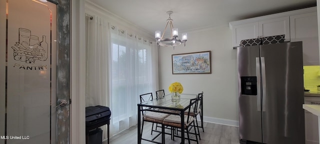 417 Highpoint Dr, Diamondhead, MS 39525 - dining space with a chandelier, light wood-style floors, ornamental molding, and baseboards