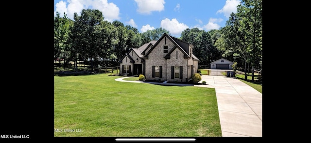 11368 Cedar Point Cv, Hernando, MS 38632 - view of front of home with an outbuilding, a front lawn, brick siding, and concrete driveway