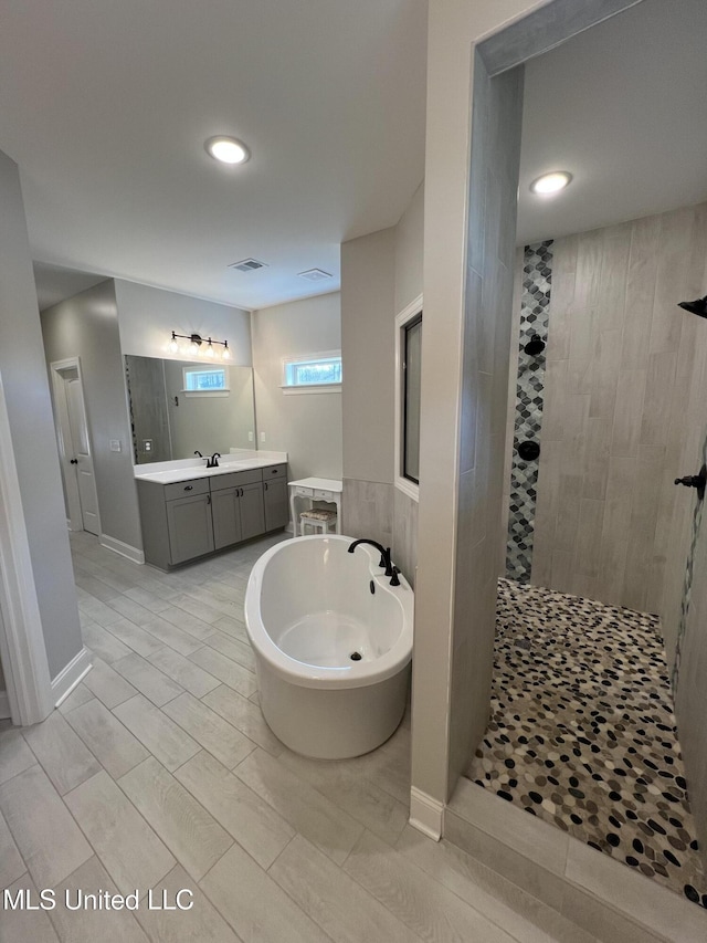 11368 Cedar Point Cv, Hernando, MS 38632 - full bath featuring walk in shower, a soaking tub, vanity, and recessed lighting