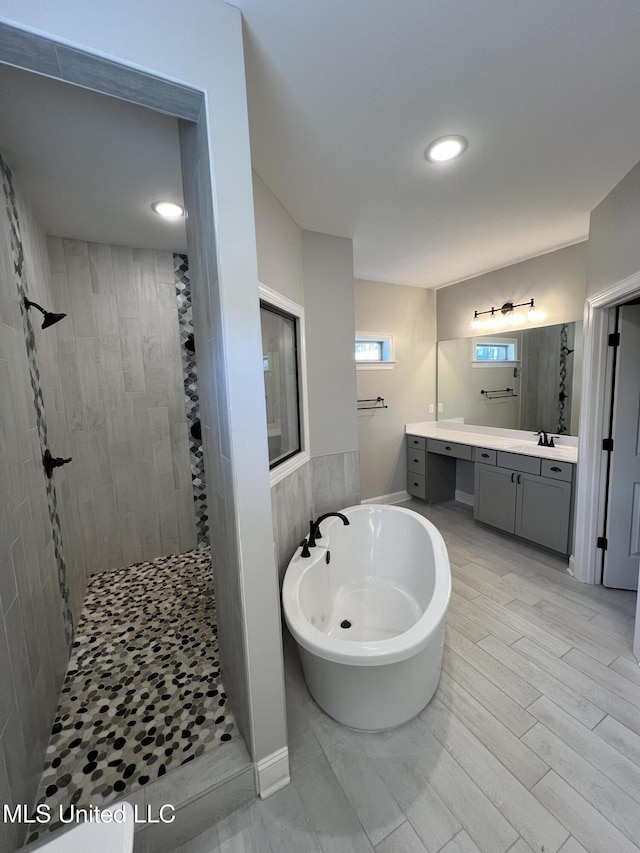 11368 Cedar Point Cv, Hernando, MS 38632 - bathroom featuring walk in shower, vanity, a freestanding tub, and recessed lighting