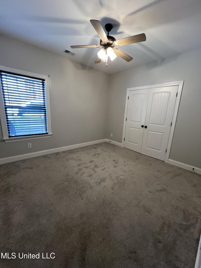 11368 Cedar Point Cv, Hernando, MS 38632 - unfurnished bedroom featuring carpet floors, a closet, baseboards, and ceiling fan