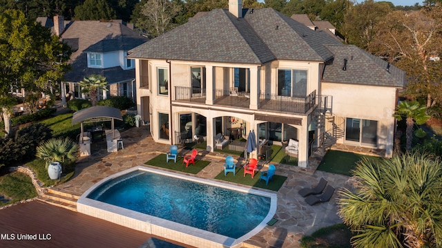 back of property with a patio and a balcony