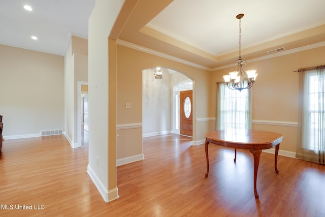 475 Wilburn Rd, Michigan City, MS 38647 - unfurnished dining area featuring arched walkways, a chandelier, light wood finished floors, ornamental molding, and baseboards
