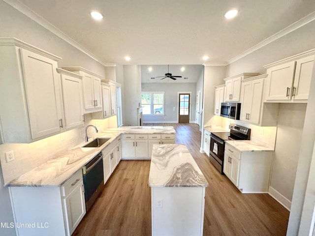 kitchen featuring wood-type flooring, kitchen peninsula, white cabinetry, ceiling fan, and stainless steel appliances