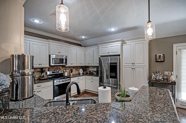 862 Willow Grande Cir, Brandon, MS 39047 - kitchen with stainless steel appliances, a sink, white cabinetry, decorative backsplash, and dark stone countertops