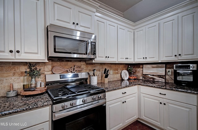 862 Willow Grande Cir, Brandon, MS 39047 - kitchen with appliances with stainless steel finishes, white cabinetry, tasteful backsplash, and dark stone counters