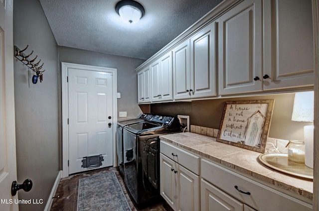 862 Willow Grande Cir, Brandon, MS 39047 - washroom with separate washer and dryer, cabinet space, a textured ceiling, and baseboards