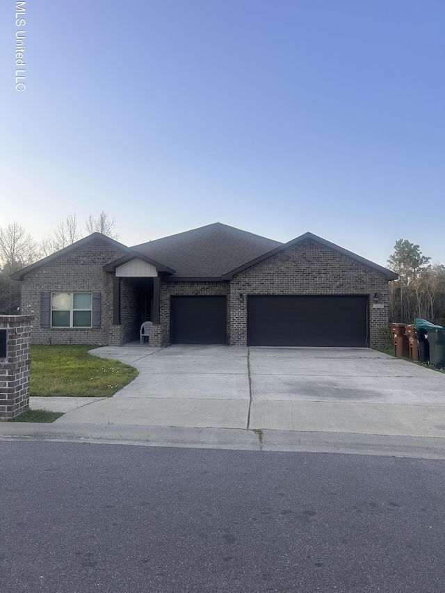 10645 Chapelwood Dr, Gulfport, MS 39503 - view of front of property with brick siding, concrete driveway, and a garage