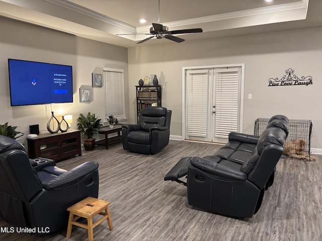 10645 Chapelwood Dr, Gulfport, MS 39503 - living area featuring wood finished floors, a ceiling fan, a tray ceiling, and ornamental molding
