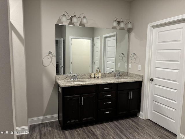 10645 Chapelwood Dr, Gulfport, MS 39503 - full bathroom featuring double vanity, wood finished floors, baseboards, and a sink