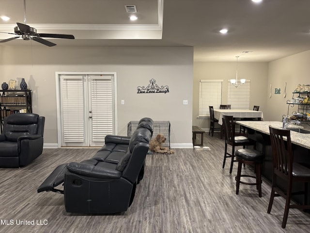 10645 Chapelwood Dr, Gulfport, MS 39503 - living room featuring visible vents, baseboards, dark wood finished floors, and ceiling fan with notable chandelier