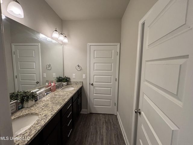 10645 Chapelwood Dr, Gulfport, MS 39503 - full bathroom with a sink, baseboards, wood finished floors, and double vanity
