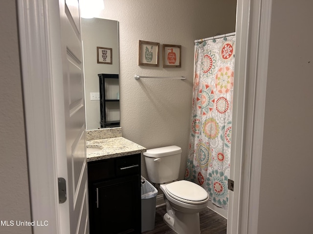 10645 Chapelwood Dr, Gulfport, MS 39503 - bathroom featuring curtained shower, toilet, wood finished floors, and vanity
